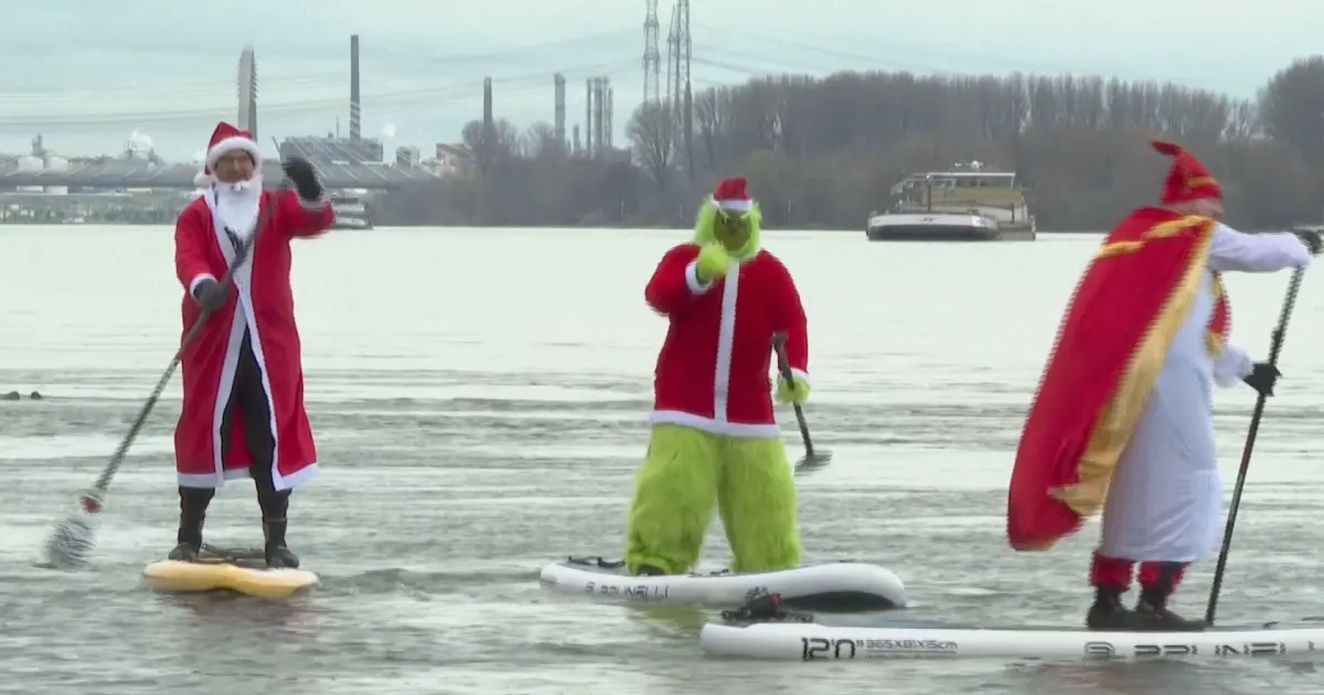 Papai Noel pratica stand up paddle pelo rio Reno na Alemanha